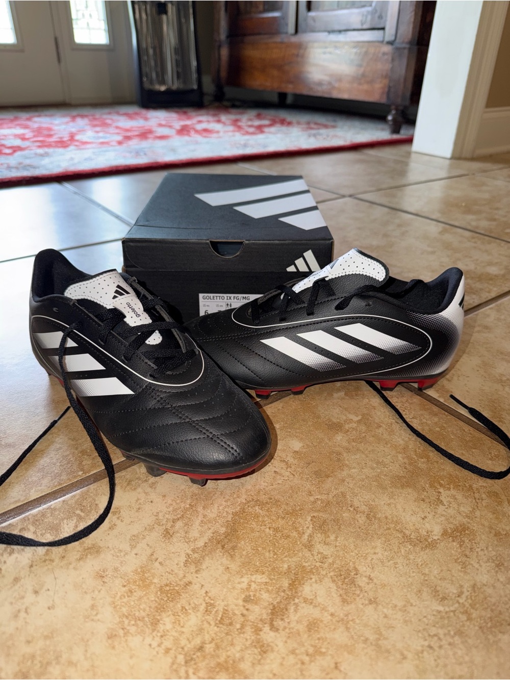 adidas Black and White Soccer Cleats with Red Stud Tips